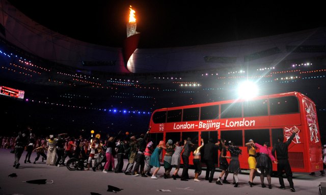 A double decker bus arrives during the Closing Ceremony at the National Stadium during the 2008 Beijing Olympic Games, China. Gareth Copley/PA Archive/PA Images