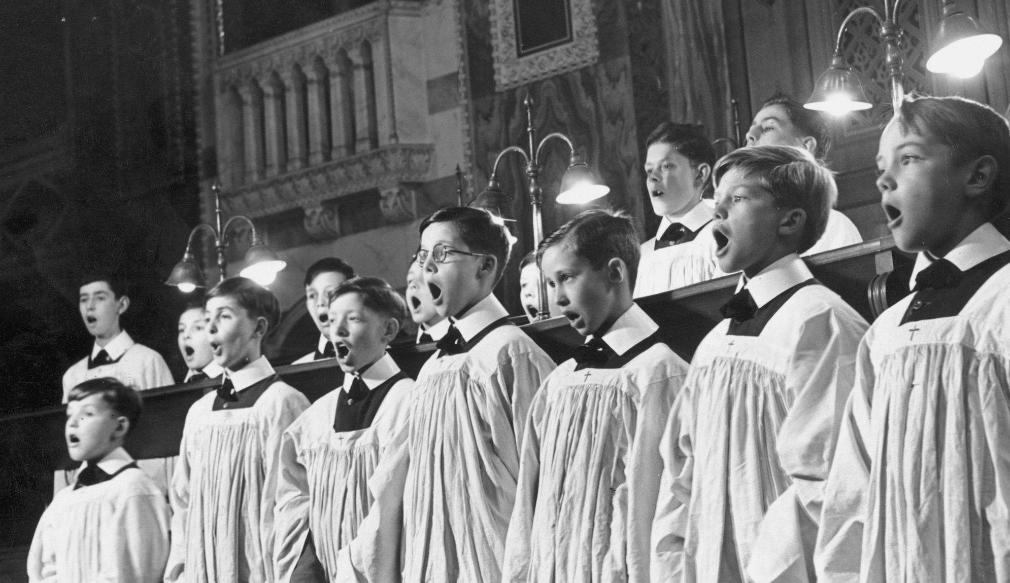 Choir boys at Westminster School singing a hymn during a service at Westminster Cathedral. June 1947. Credit: Getty Images