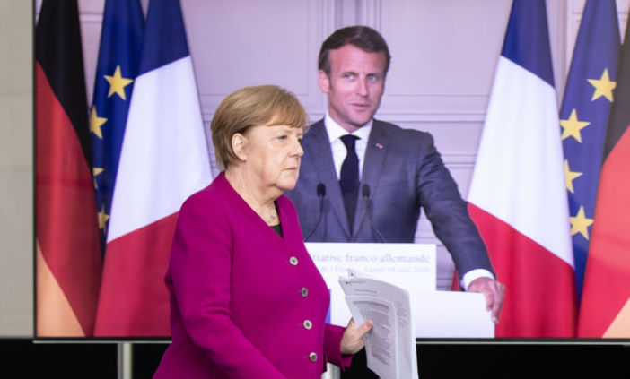 German Chancellor Angela Merkel and French President Emmanuel Macron, seen present live via video, announced they intend to launch a joint European Union recovery initiative worth €500 billion. Credit: Andreas Gora - Getty Images