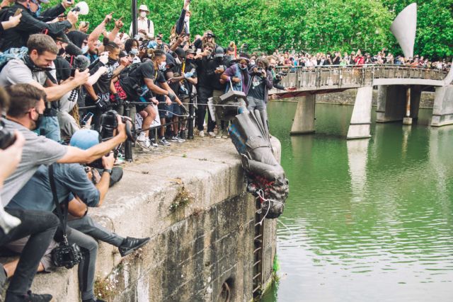The statue of Colston is pushed into the River Avon. (Photo by Giulia Spadafora/NurPhoto via Getty Images)