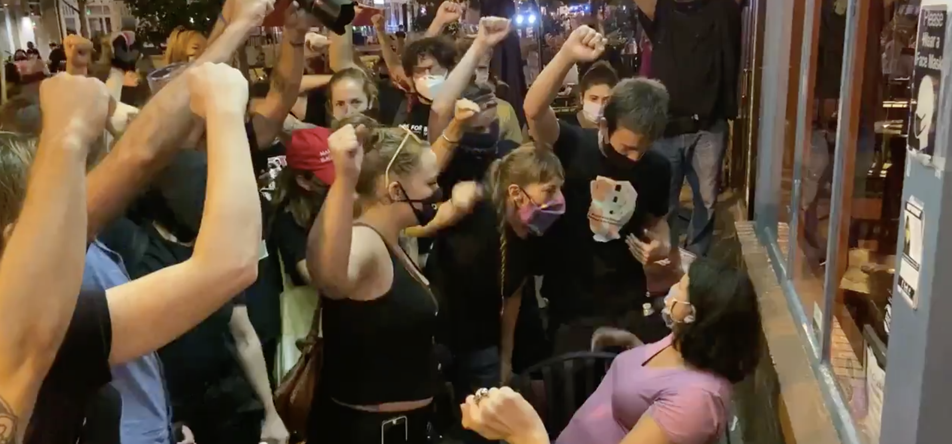 Lauren Victor sits calmly as BLM protesters demand she raises her fist