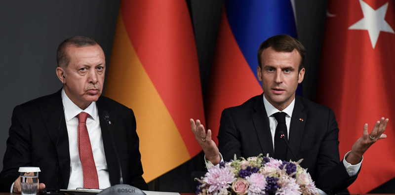Turkey's President Recep Tayyip Erdogan sits by French President Emmanuel Macron in Istanbul, 2018