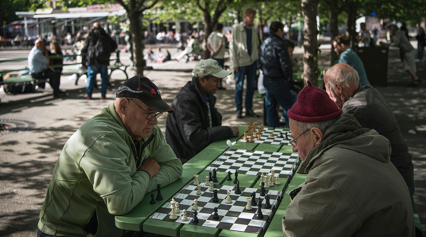 People play chess at a park in Stockholm. Credit: Getty