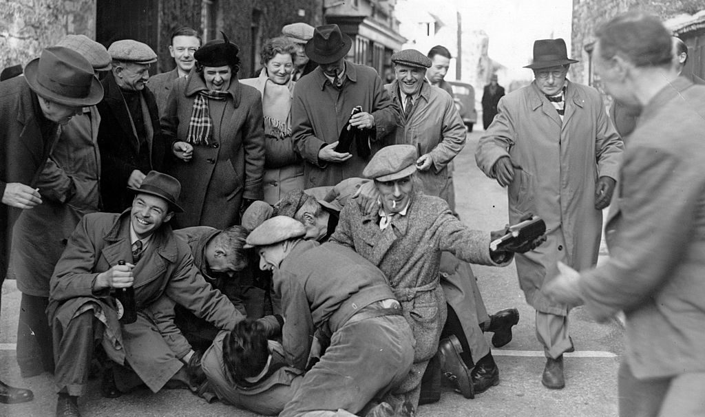 Marblers and Stonecutters search apprentices for beer bottles in a Shrove Tuesday custom. Credit: Getty 