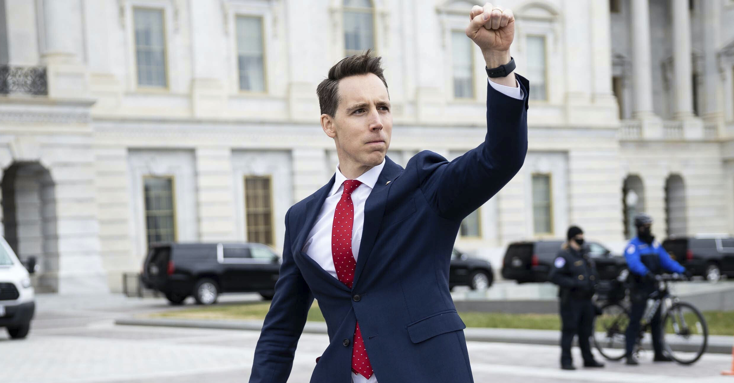 Sen. Josh Hawley gestures towards pro-Trump supporters on Capitol Hill.