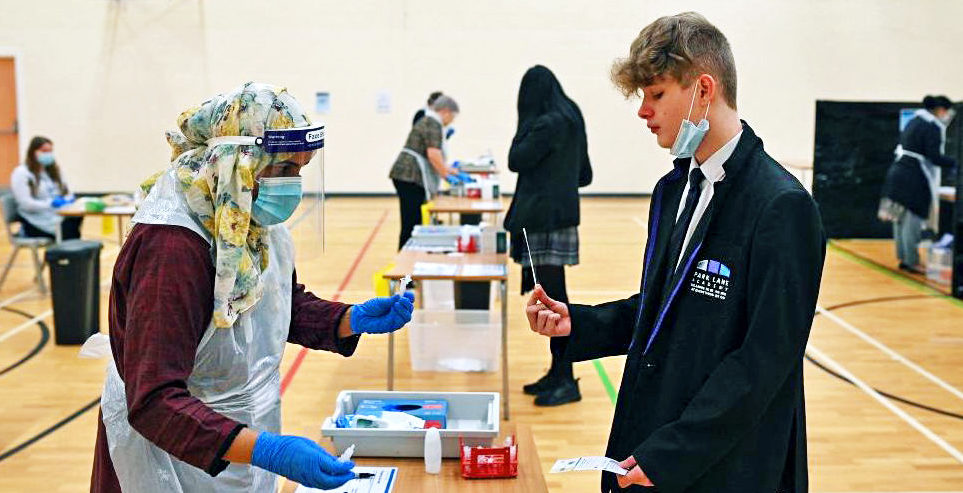 Students take lateral flow Covid-19 tests in the Sports Hall at Park Lane Academy in Halifax, England. Credit: Getty