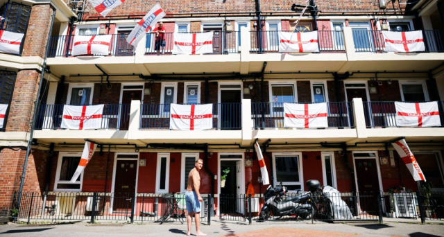 St George's flags fly from residents' homes at the Kirby Estate in Bermondsey. (Photo by TOLGA AKMEN/AFP via Getty Images)