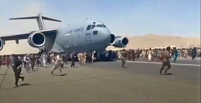 Desperate Afghans cling to a US military plane leaving Kabul