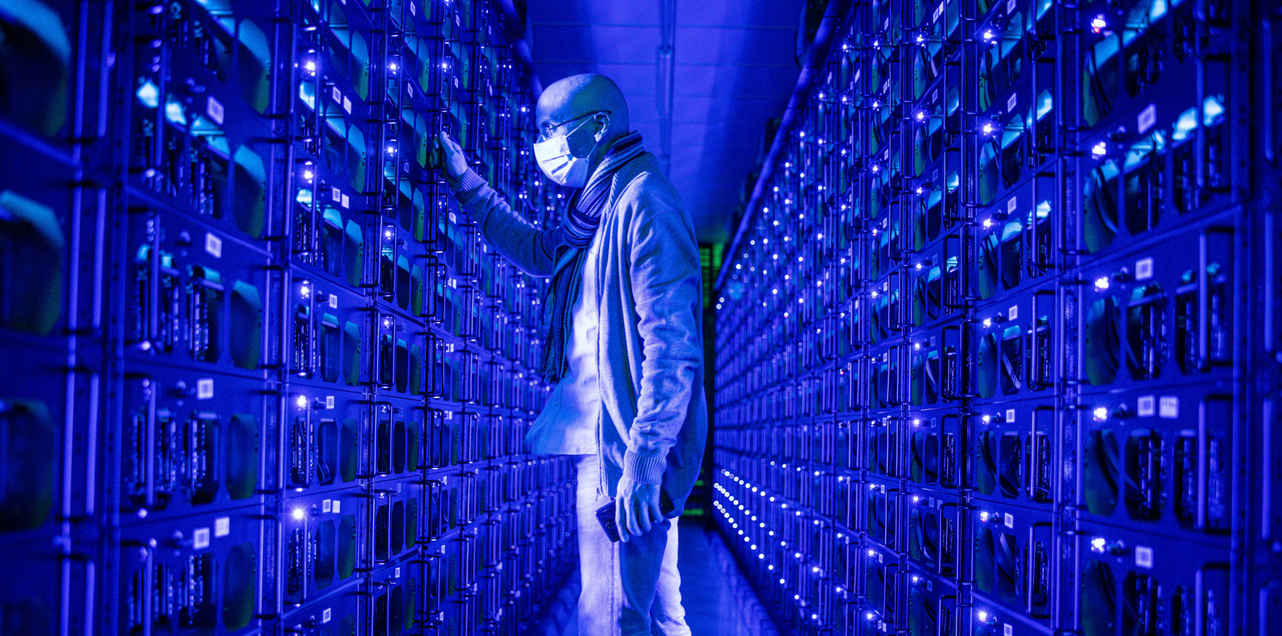 An employee inspects a crypto mine. Credit: Getty