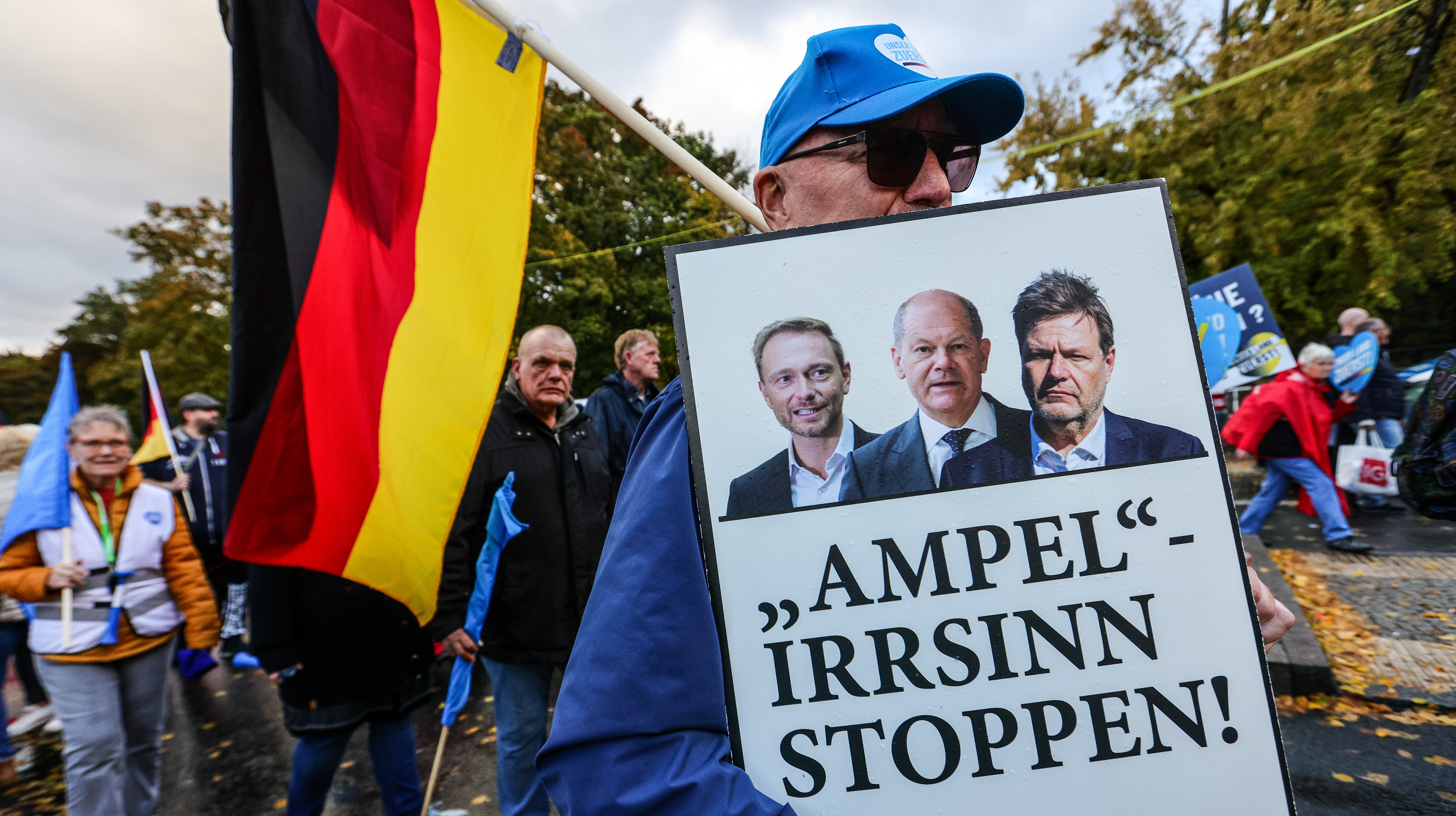 A banner depicting Chancellor Olaf Scholz, Finance Minister Christian Lindner and Climate minister Robert Habeck