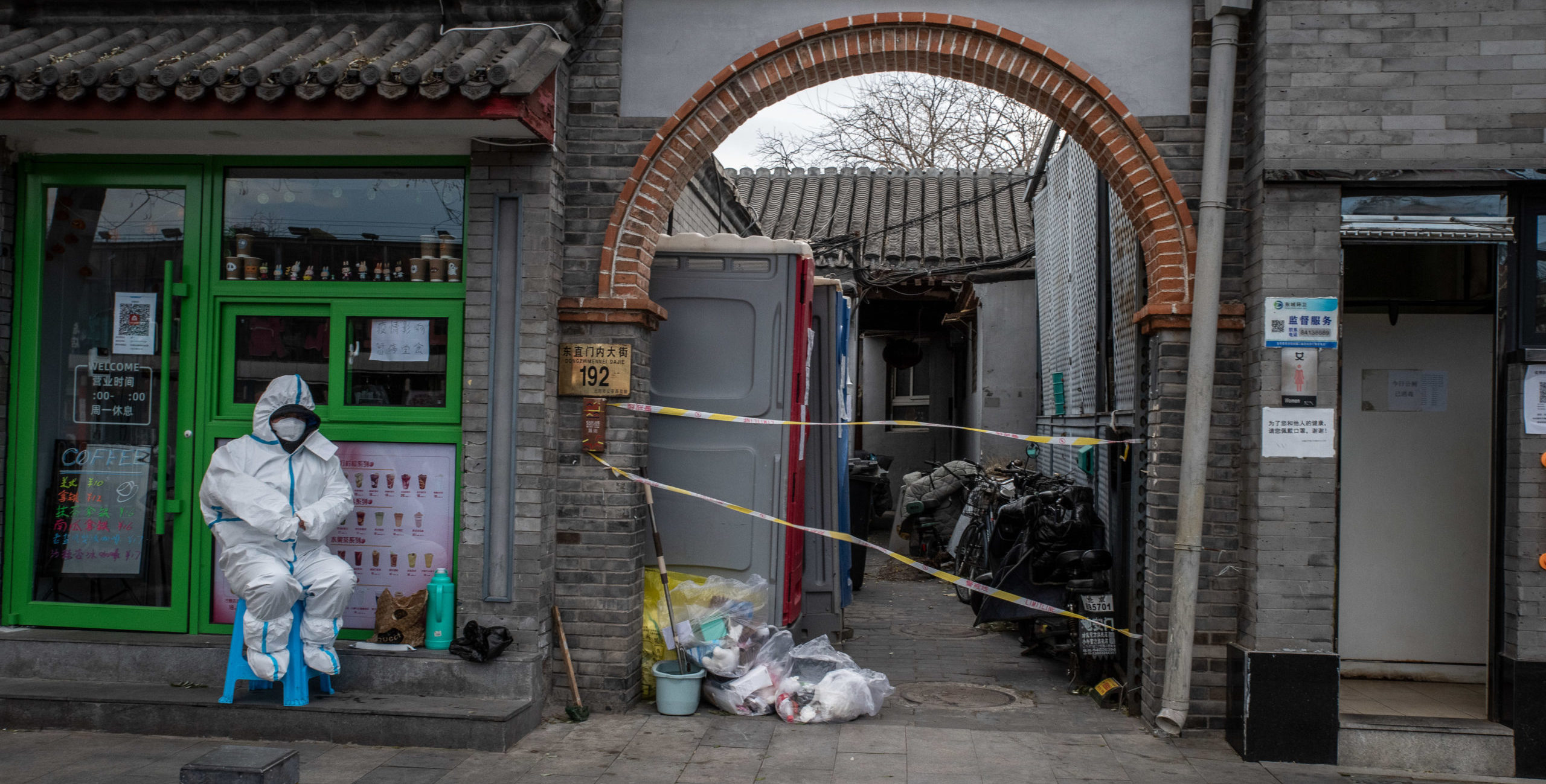 A Covid-prevention worker guards the entrance of a residential compound placed under lockdown in Beijing in November 2022. Credit: Getty.