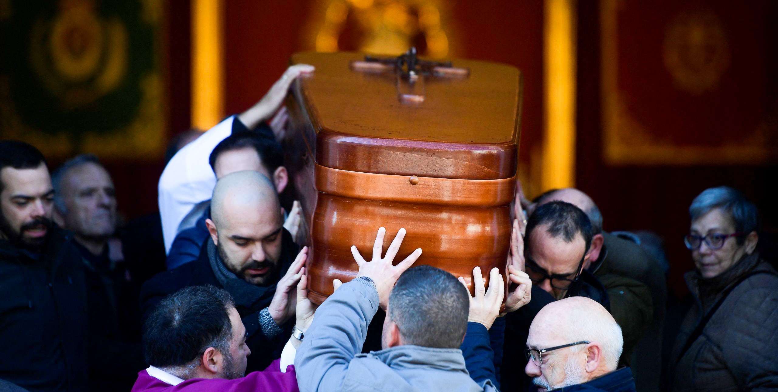 Pallbearers carry the casket of Diego Valencia two days after he was killed. Credit: Getty.