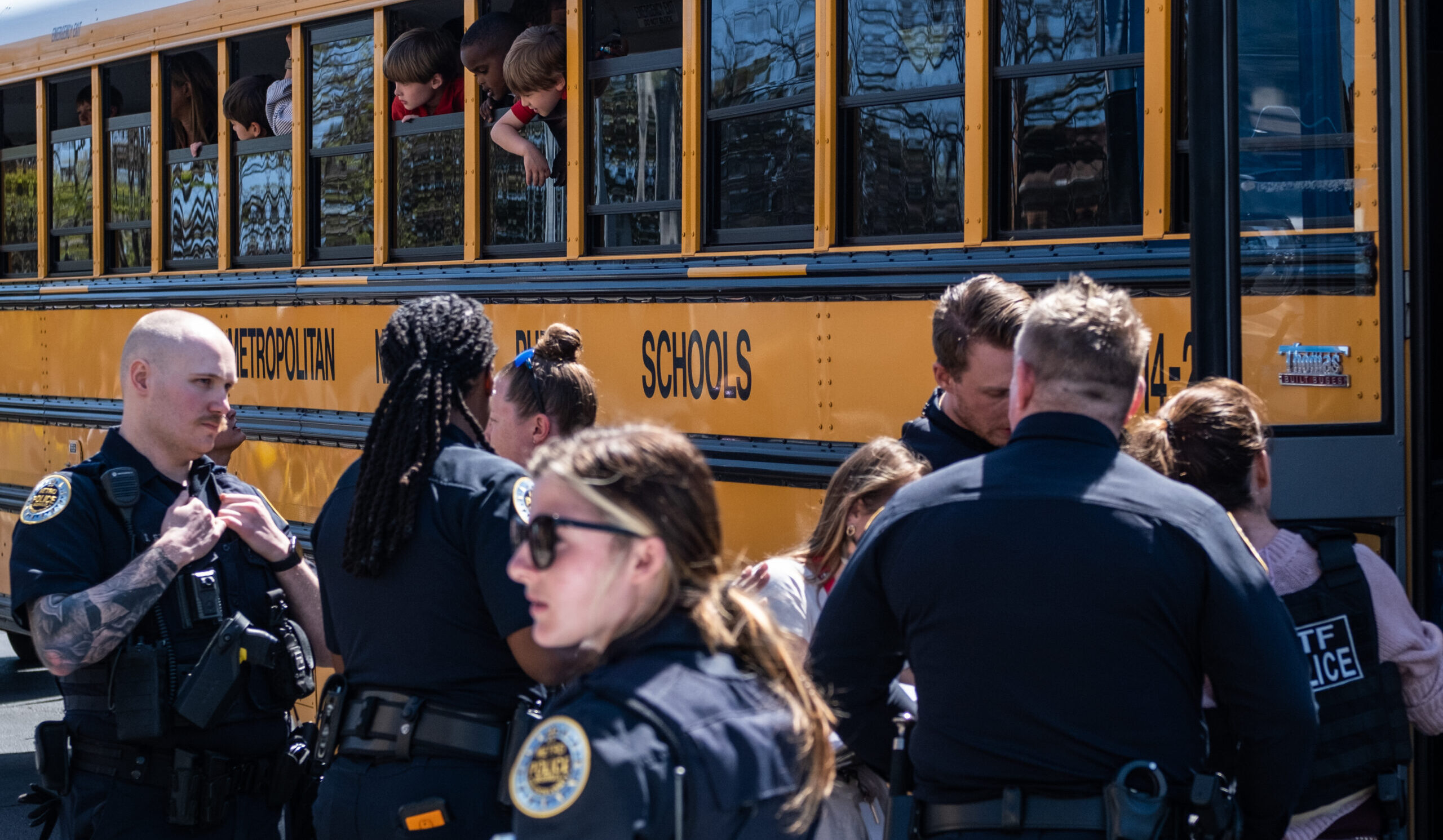 School buses with children arrive to be reunited with their families after the shooting on 27th March. Credit: Getty