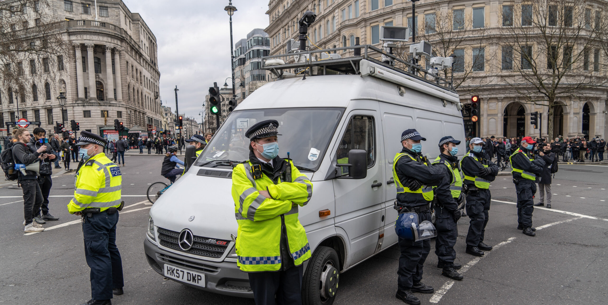 Police officers protect a facial recognition van in London. Credit: Getty