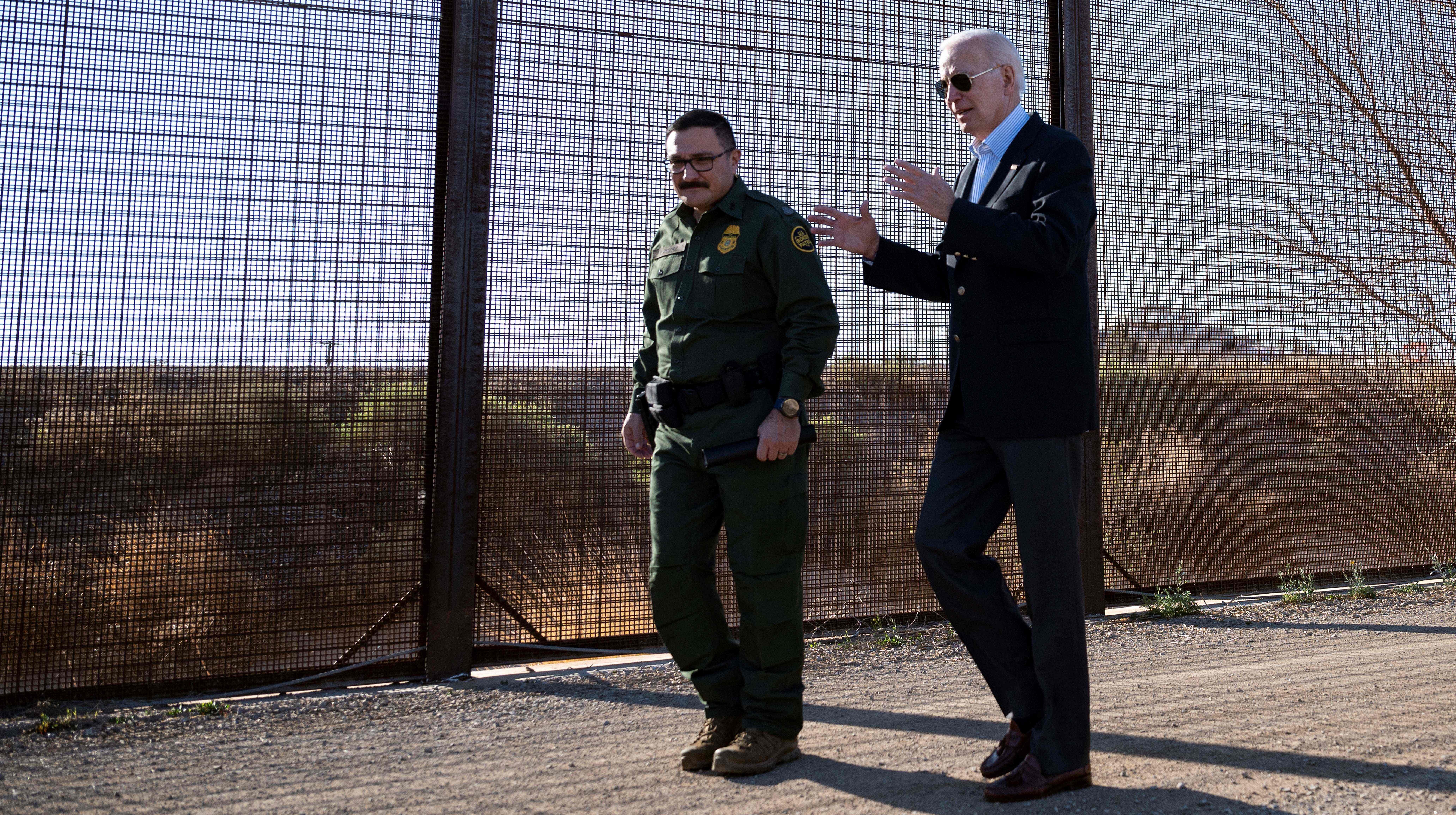 Joe Biden with a member of the US Border Patrol at the border fence in El Paso, Texas this year. Credit: Getty
