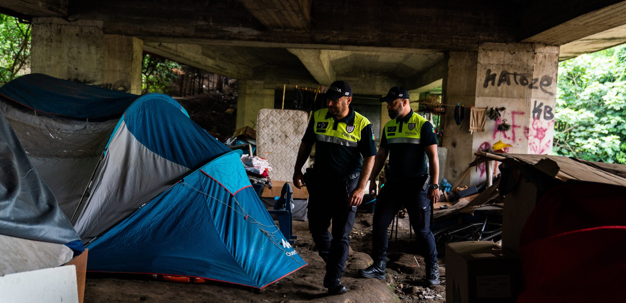 Police officers inspect a popular underpass for drug-takers. Credit: Getty