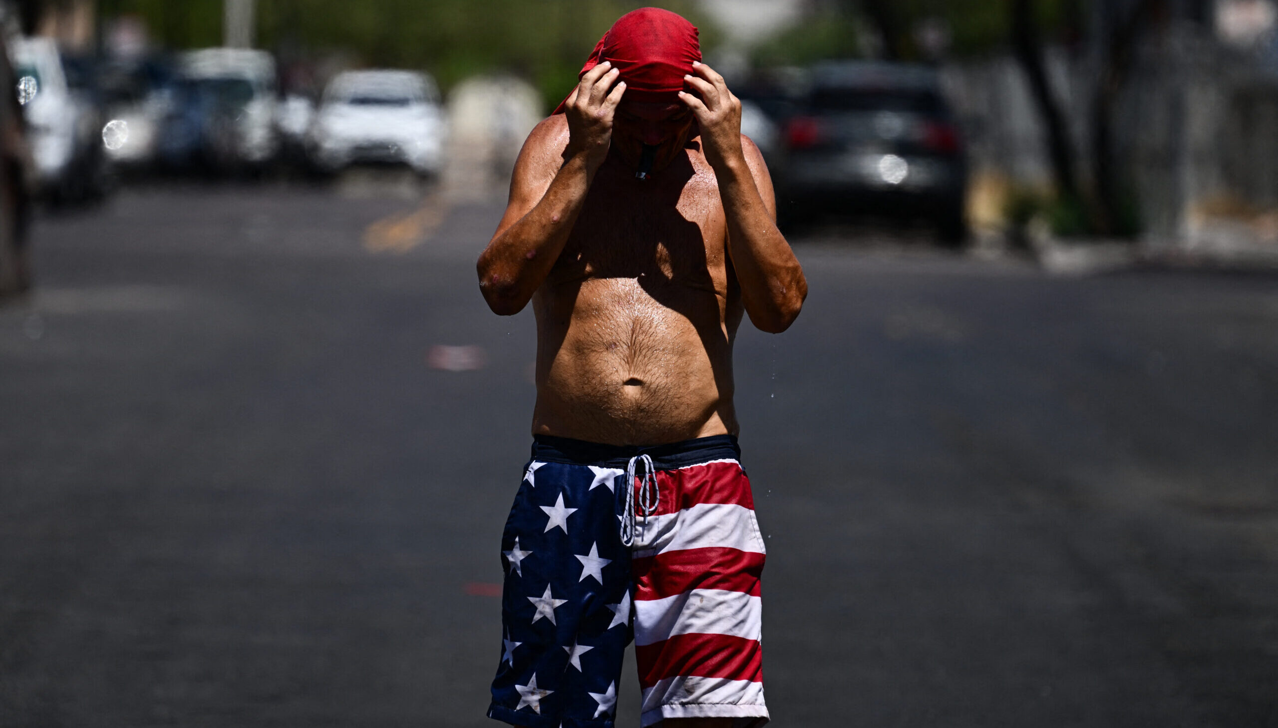 An Arizona resident struggles through a record heatwave last month. Credit: Getty