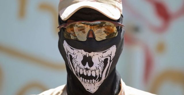 New mask, same crimes. (AHMAD AL-RUBAYE/AFP via Getty Images)