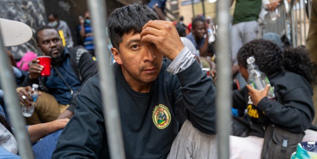 A sits outside of processing centre in NYC (Spencer Platt/Getty Images)