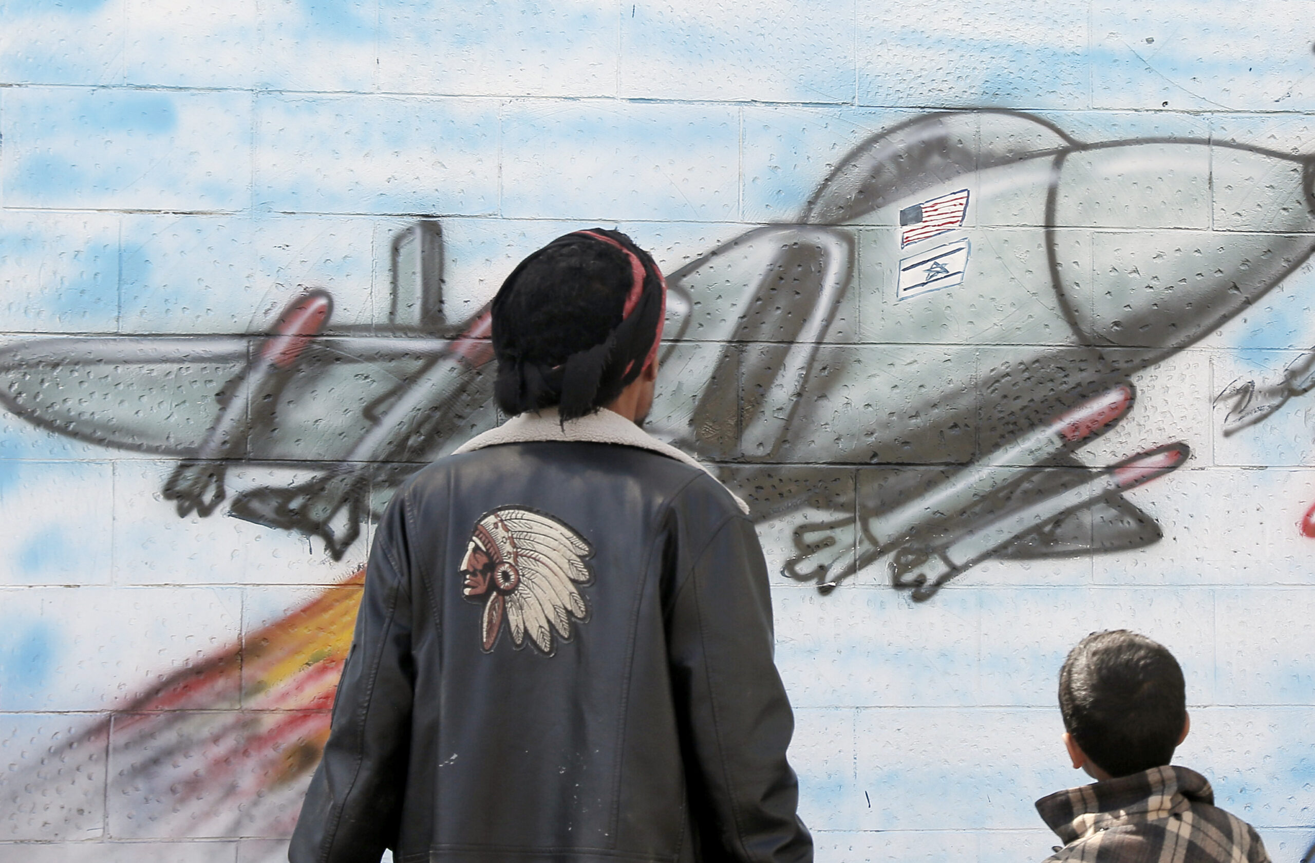 Artworks created this month in Yemen depict a jet craft carrying the American and Israeli flags. Credit: Getty