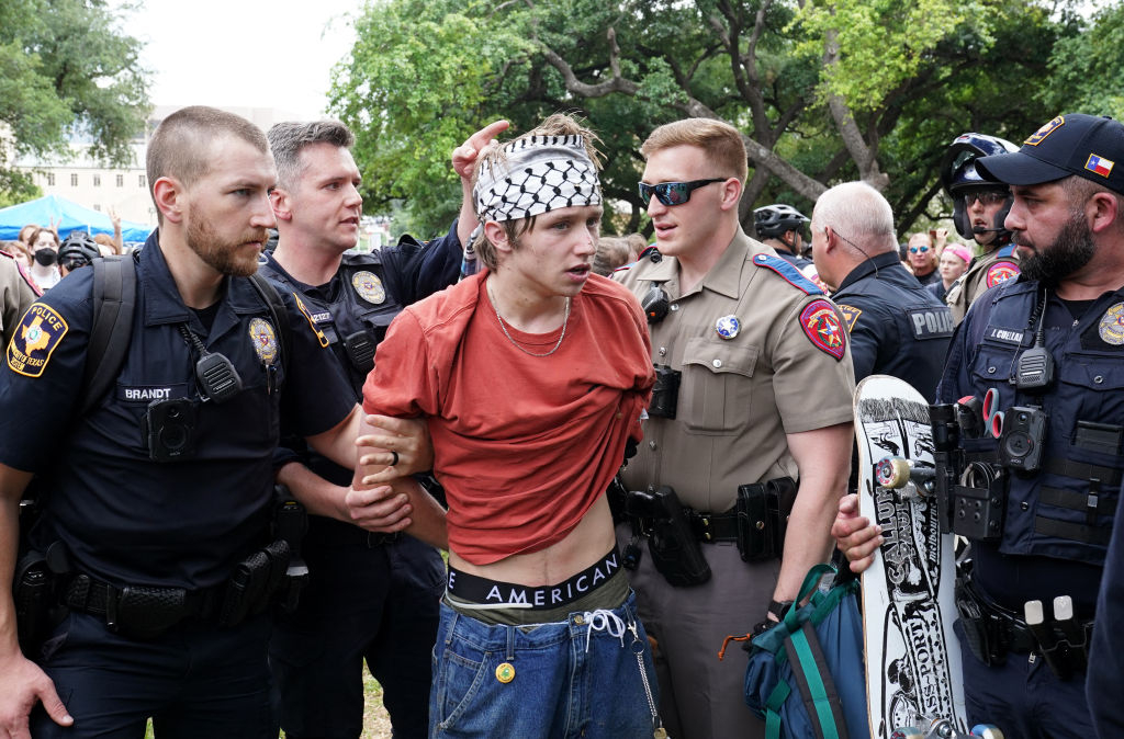 A protestor is detained at UT Austin on Wednesday. Credit: Getty 