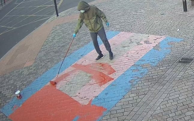 An unidentified vandal has painted over Pride flags outside Forest Gate station. Credit: Met Police