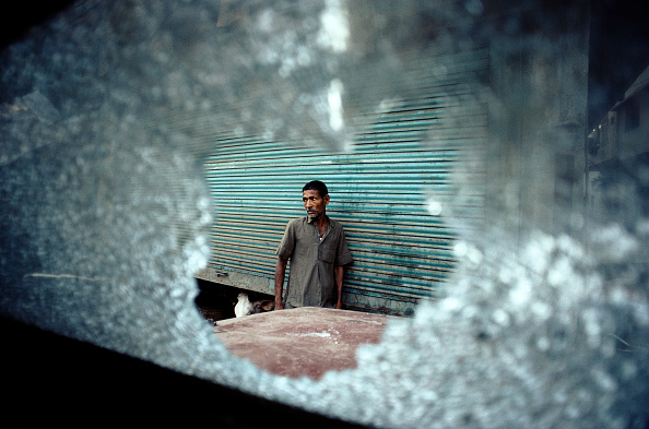 Muslim shopkeeper outside his building during Hindu-Muslim riots in November 1990  (Photo by In Pictures Ltd./Corbis via Getty Images)
