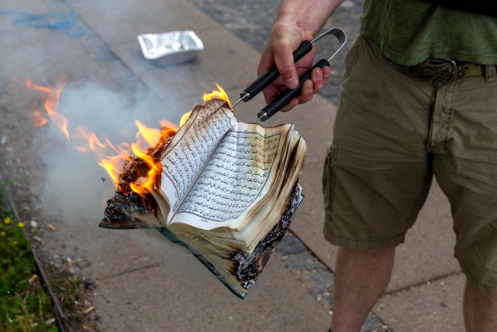 A Quran is burned in Copenhagen last year, before the law's introduction. Credit: Getty