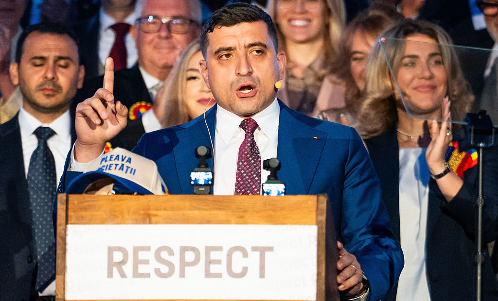 Populist candidate George Simion speaks to supporters last night after the publication of initial exit polls. Credit: Getty