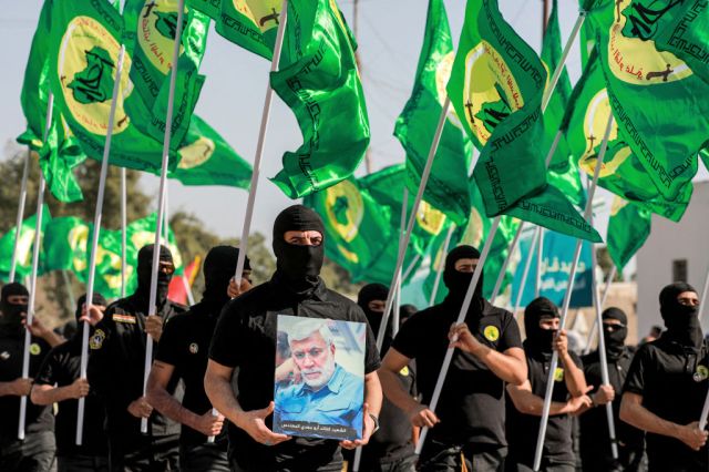 Militiamen linked to the Popular Mobilisation Forces. (Murtaja Lateef/AFP)