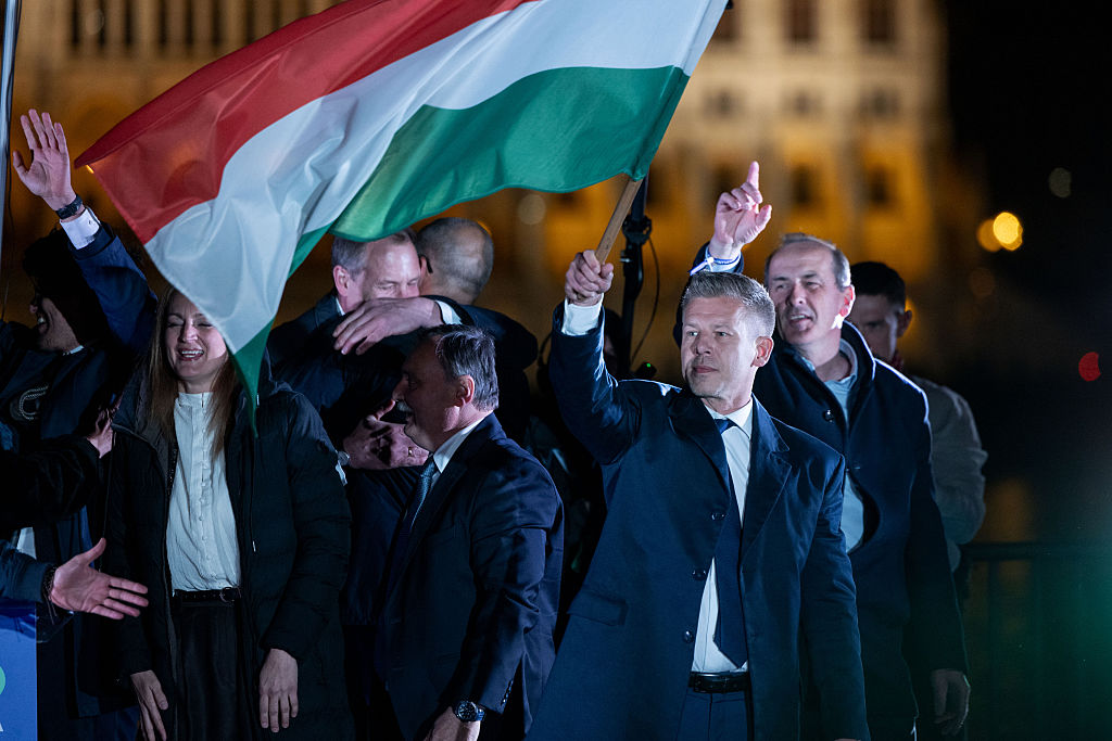 Péter Magyar celebrates on the banks of the Danube with supporters last night. Credit: Getty
