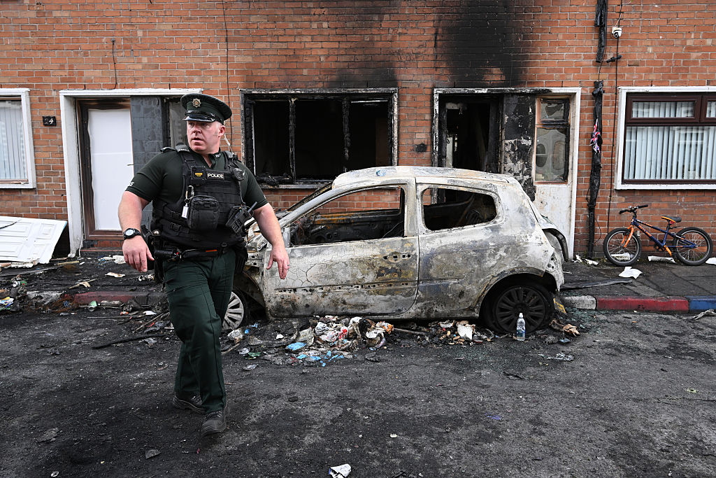 Officers attend the aftermath of Tuesday night’s protests in Belfast. Credit: Getty
