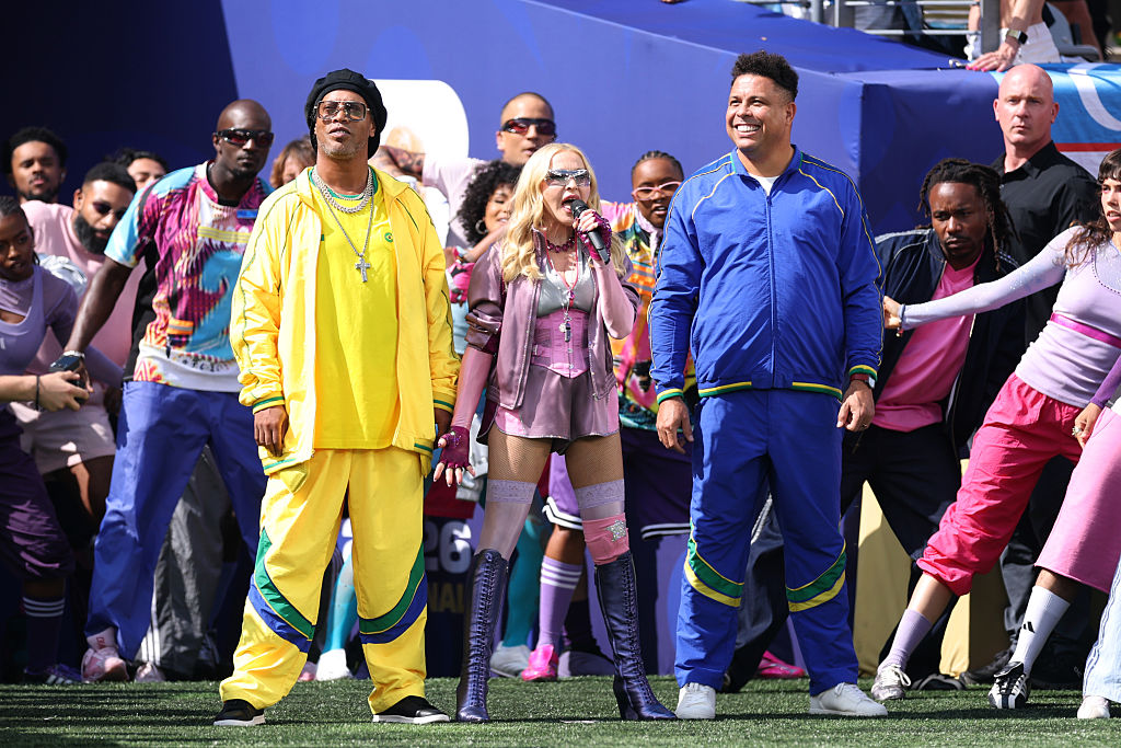 Madonna performs at the World Cup half-time show yesterday, flanked by Brazilian football legends Ronaldinho and Ronaldo. Credit: Getty